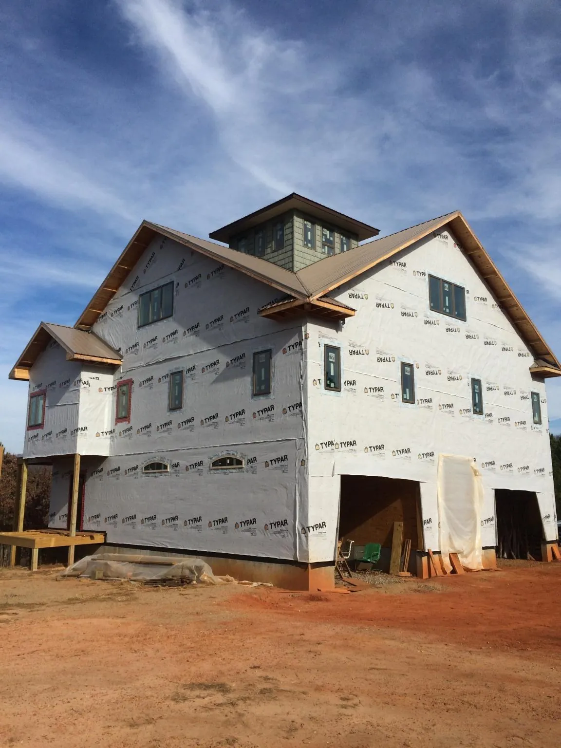 New two story house under construction with a cupola and gabled roofs in Plymouth